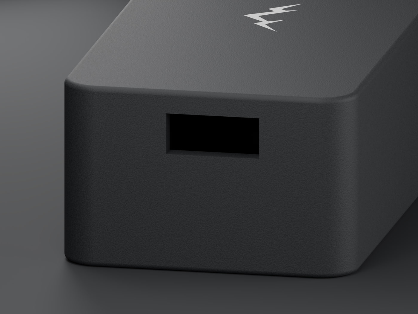 Close view of the USB-C opening cut into the short end of the NOMAE enclosure, with the textured polymer surface visible